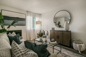 Albuquerque apartment for rent - A living room with a grey couch and a green pillow.