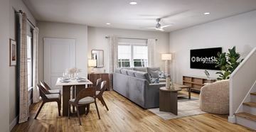 Wendell apartment for rent - A well-lit living room with a dining table and a couch.