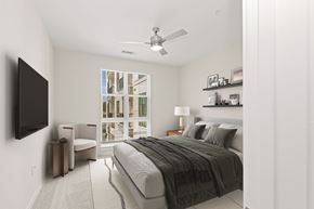 Charlotte apartment for rent - A bedroom with a large bed and a flat screen TV mounted on the wall.