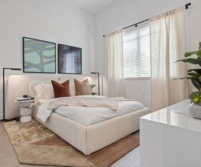 Doral apartment for rent - A bedroom with a large bed and two framed pictures on the wall.