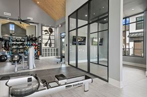 Arlington apartment for rent - a home gym with glass doors and a weights rack