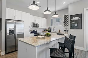 Arlington apartment for rent - a kitchen with a marble counter top and a stainless steel refrigerator