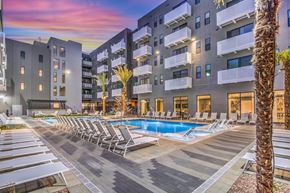 Las Vegas apartment for rent - an apartment complex with a swimming pool and chaise lounge chairs