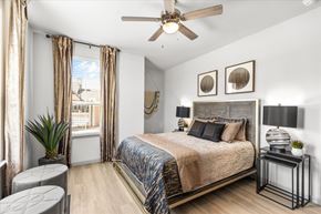 Red Oak apartment for rent - a bedroom with a ceiling fan and a large window