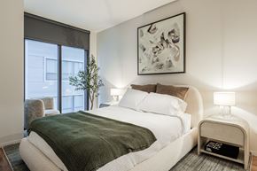 Madison apartment for rent - A bedroom with a large bed and a painting on the wall.