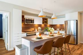 Arlington apartment for rent - a kitchen with white cabinets and stainless steel appliances