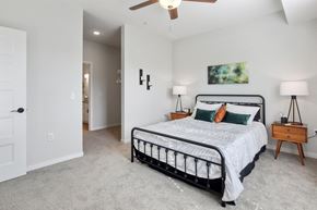 Shakopee apartment for rent - a bedroom with a bed and a ceiling fan