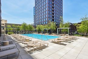 Chicago apartment for rent - A pool surrounded by sun loungers and trees.
