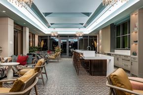 Washington apartment for rent - A well-lit dining area with a long table and chairs.
