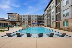Prosper apartment for rent - A swimming pool in front of apartment buildings.