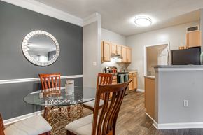 Fairburn apartment for rent - A kitchen and a dining area with a table and chairs at Peachtree Landing apartments for rent 30213.
