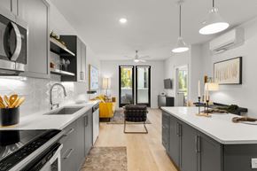 Sacramento apartment for rent - a kitchen with white counter tops and gray cabinets