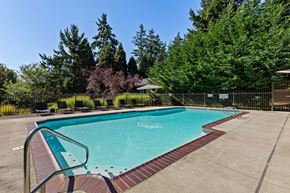 Kirkland apartment for rent - A small pool surrounded by a fence and trees.
