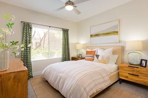 Glendale apartment for rent - A bedroom with a bed, nightstand, and a painting on the wall.