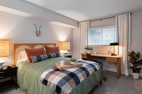 Westminster apartment for rent - A bedroom with a bed, desk, and chair.