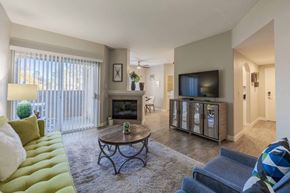 Las Vegas apartment for rent - A living room with a green couch, a coffee table, and a television.
