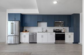 Charleston apartment for rent - A kitchen with blue cabinets and stainless steel appliances.