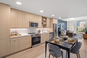 Raleigh apartment for rent - A modern kitchen with a dining table set for two.