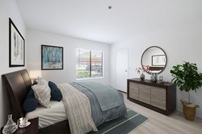 Ontario apartment for rent - a bedroom with a bed and dresser in a 555 waverly unit