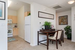 San Diego apartment for rent - A kitchen with a table and chairs in the middle of the room.
