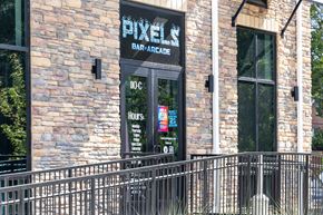 Rolesville apartment for rent - A brick building with a sign that says Pixel Bar & Grill.