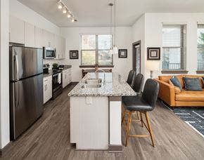 Sandy Springs apartment for rent - A modern kitchen with a large island and a refrigerator.