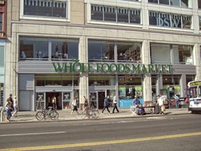 New York apartment for rent - people walking on the sidewalk in front of a building with the words whole foods market on it