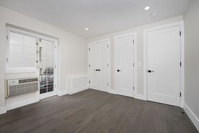 New York apartment for rent - a bedroom with hardwood floors and white walls