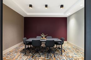 Philadelphia apartment for rent - a conference room with a table and chairs and a red wall