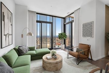 Seattle apartment for rent - A living room with a green couch and a brown chair.