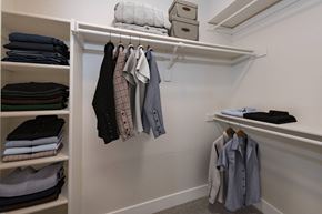 Westminster apartment for rent - A white closet with clothes hanging and folded on shelves.