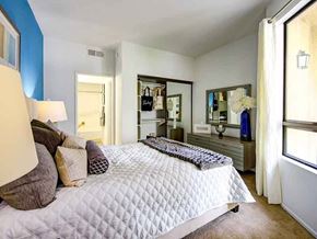 Long Beach apartment for rent - A bedroom with a bed, nightstand, and mirror.