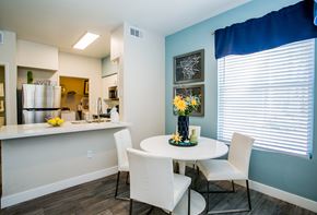 Las Vegas apartment for rent - A modern kitchen with a dining table and chairs at The Layne at Peccole Ranch modern apartments in Las Vegas, NV.