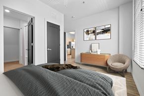 Simpsonville apartment for rent - a bedroom with a bed and a chair in a 555 waverly unit