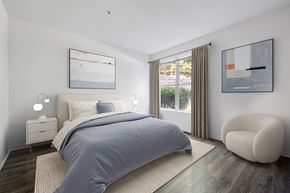 Durham apartment for rent - A bedroom with a large bed and a chair.