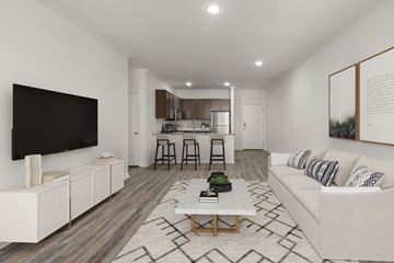 Huntersville apartment for rent - A modern living room with a white couch and a television.