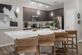 Phoenix apartment for rent - A kitchen with a white table and brown chairs.
