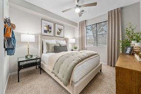 Phoenix apartment for rent - A bedroom with a large bed and a ceiling fan.
