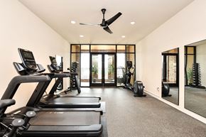 Simpsonville apartment for rent - a gym with treadmills and a ceiling fan