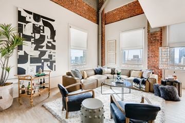 San Diego apartment for rent - A living room with a large sofa set and a large abstract painting on the wall.