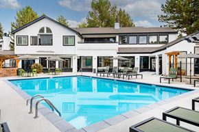 Westminster apartment for rent - A large white house with a pool in the backyard.