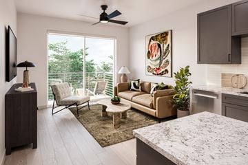 Fort Worth apartment for rent - A living room with a couch, chair, and a painting on the wall.