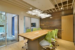 Berkeley apartment for rent - A conference room with a long table and green chairs.