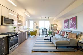 Berkeley apartment for rent - A modern kitchen with a large island and a living room with a couch.