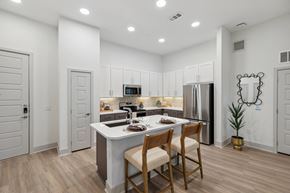 Houston apartment for rent - a kitchen with a white counter top and a stainless steel refrigerator at Alta Sunset Heights, Houston, Texas