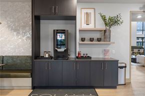 Denver apartment for rent - A modern kitchen with a black countertop and cabinets.