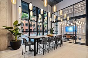 Sarasota apartment for rent - A modern dining room with a large table and chairs.