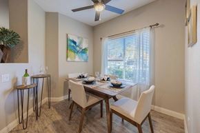 Las Vegas apartment for rent - A dining room with a table set for four and a ceiling fan.