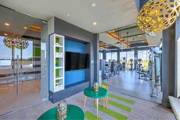 Houston apartment for rent - A modern living room with a green table and a television.