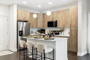 Waldorf apartment for rent - A kitchen with a white counter and bar stools.
